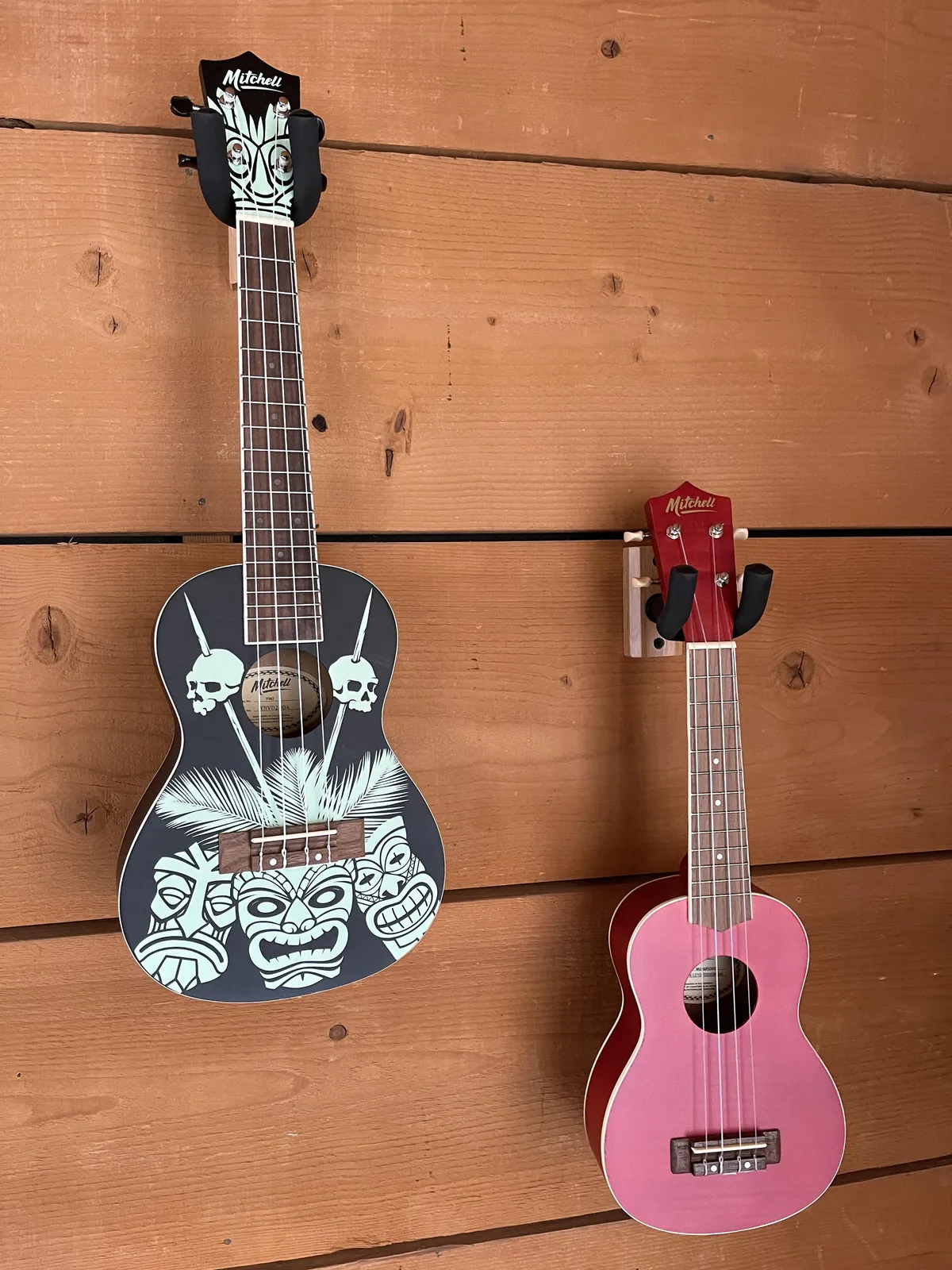 Decorative ukuleles hung on a wooden wall suggest opportunities for musical creativity and casual gatherings, adding a playful, artistic touch to the living space.